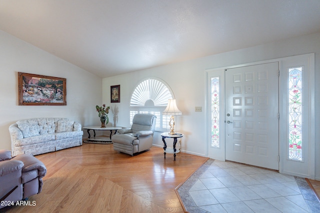 tiled foyer with a wealth of natural light and vaulted ceiling