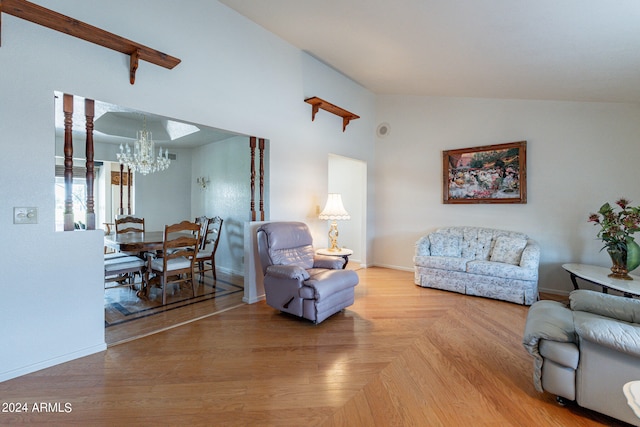 living room featuring light wood-type flooring, lofted ceiling, and an inviting chandelier