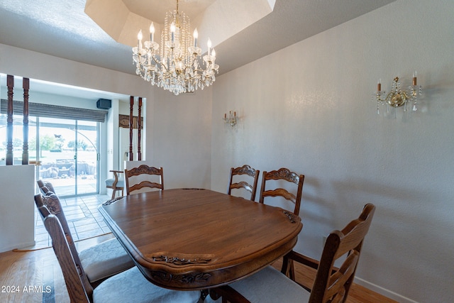 dining area featuring a notable chandelier and light wood-type flooring