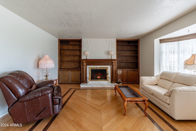 living room featuring a textured ceiling and light wood-type flooring