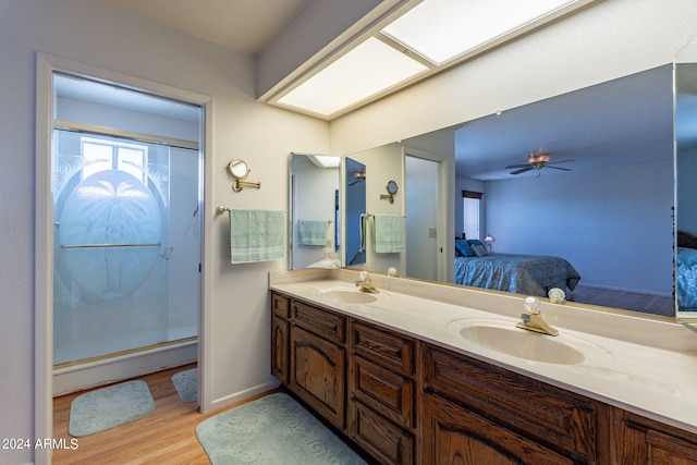 bathroom with vanity, hardwood / wood-style floors, ceiling fan, and a shower with shower door