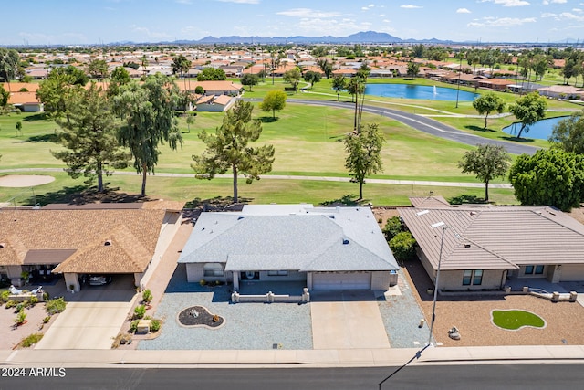 drone / aerial view with a water and mountain view