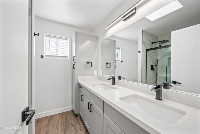 bathroom featuring vanity, hardwood / wood-style flooring, and a shower with door