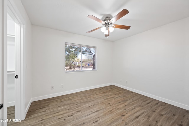 empty room featuring ceiling fan and dark wood-type flooring