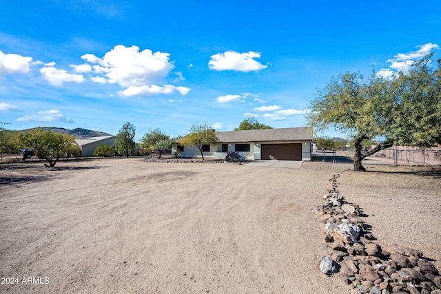 ranch-style home with a mountain view and a garage