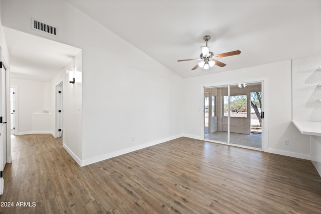 unfurnished room featuring dark hardwood / wood-style floors, vaulted ceiling, and ceiling fan