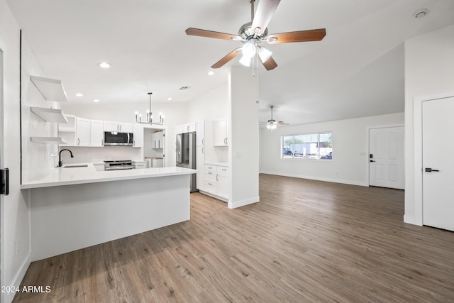 kitchen with white cabinets, light hardwood / wood-style floors, kitchen peninsula, and stainless steel appliances