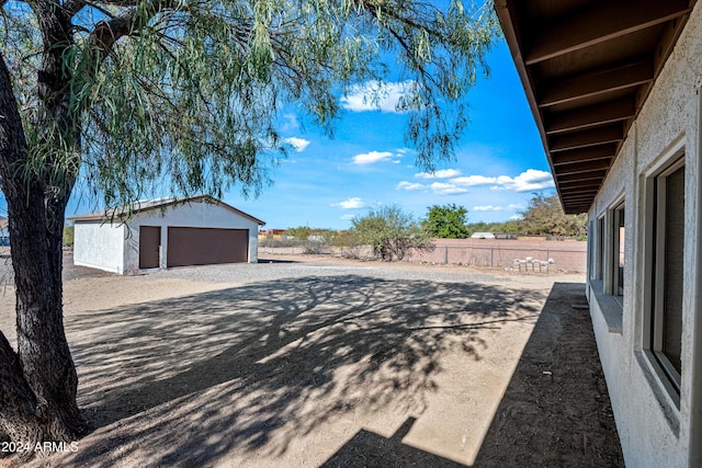 view of yard with an outdoor structure and a garage