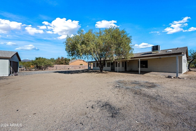 rear view of house with central air condition unit