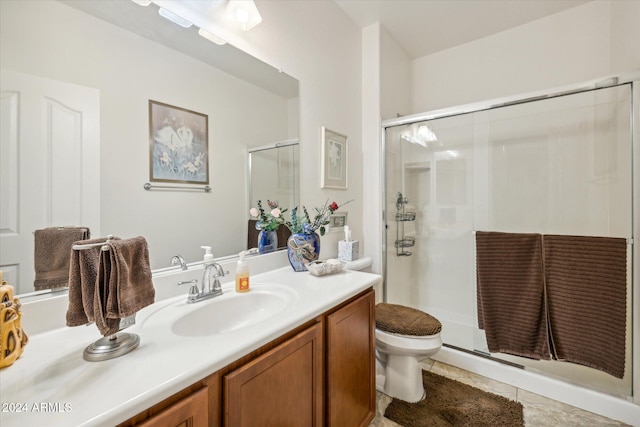 full bathroom featuring tile patterned floors, toilet, a stall shower, and vanity