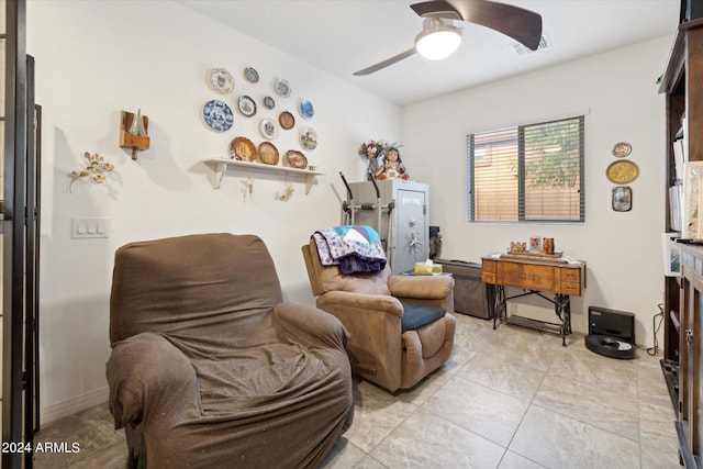 living area with a ceiling fan, visible vents, and baseboards