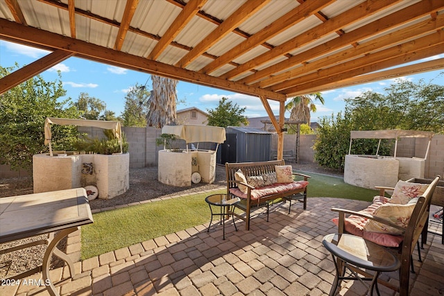 view of patio / terrace with a fenced backyard, a storage unit, and an outdoor structure