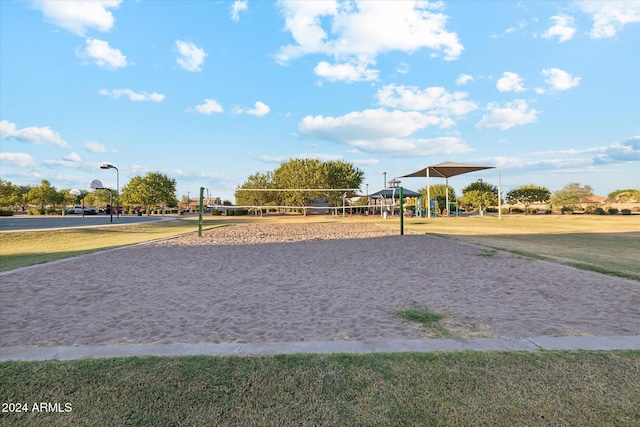 surrounding community with a yard and volleyball court