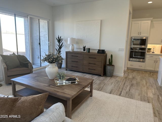 living room with light hardwood / wood-style flooring