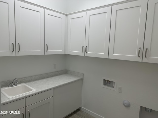 clothes washing area featuring cabinets, hookup for a washing machine, and sink