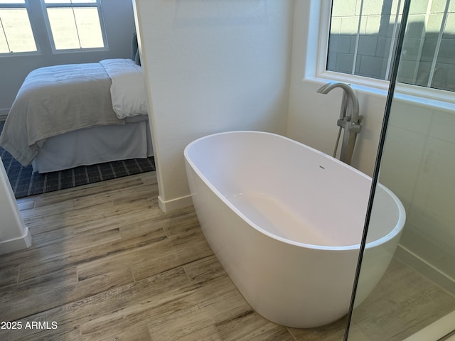 bathroom featuring wood-type flooring and a bathtub