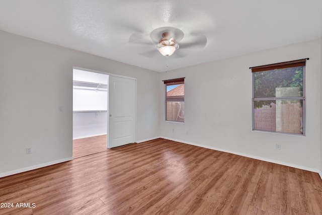 unfurnished room featuring ceiling fan and hardwood / wood-style floors