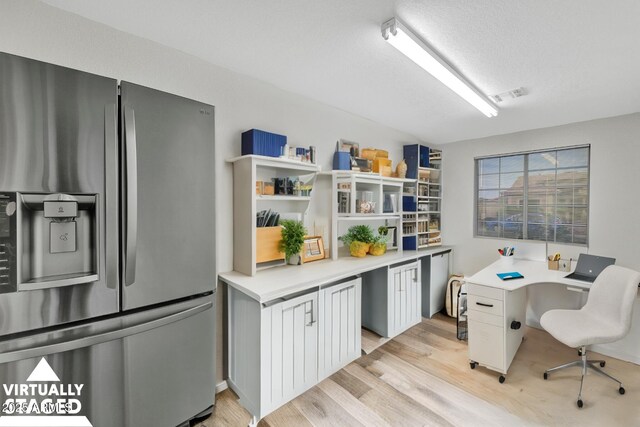 unfurnished room featuring light hardwood / wood-style flooring, ceiling fan, and separate washer and dryer