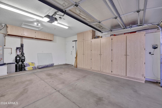 garage featuring gas water heater and a garage door opener