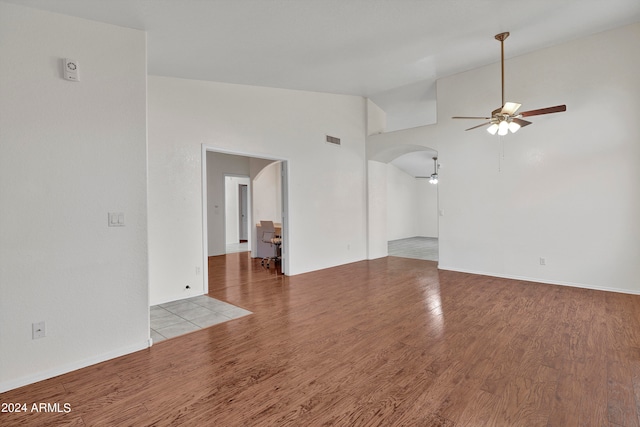 interior space with high vaulted ceiling, hardwood / wood-style floors, and ceiling fan