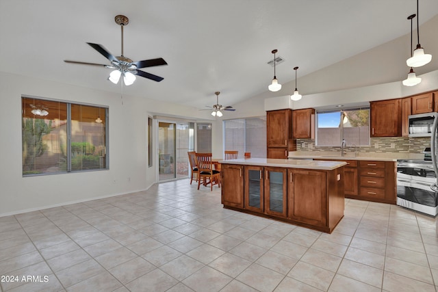 kitchen with vaulted ceiling, sink, a center island, ceiling fan, and appliances with stainless steel finishes