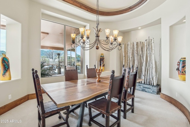 dining space featuring light colored carpet, baseboards, and an inviting chandelier