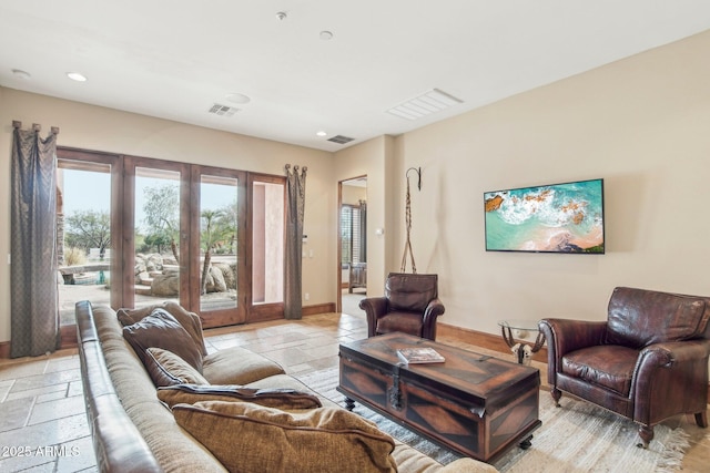 living room with recessed lighting, baseboards, visible vents, and stone tile floors