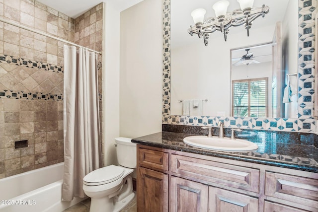 bathroom with shower / bath combo, ceiling fan, vanity, and toilet