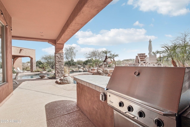 view of patio / terrace featuring a pool, a grill, and area for grilling