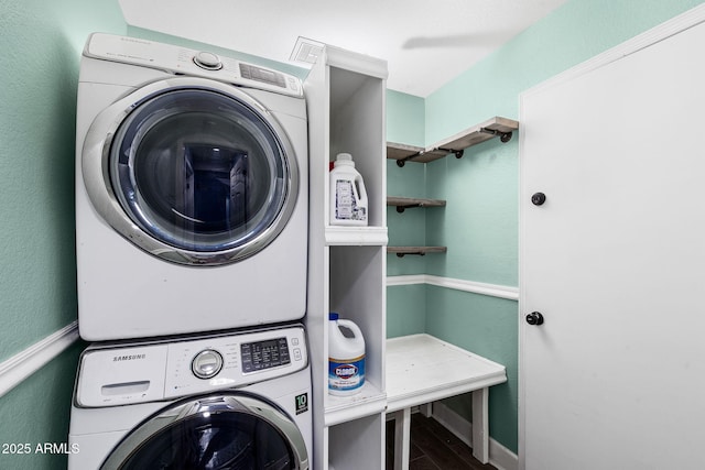 5841 W Kesler St, Chandler, AZ 85226 - laundry area featuring stacked washer / drying machine, wood finished floors, and baseboards
