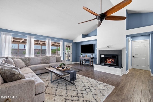5841 W Kesler St, Chandler, AZ 85226 - living room featuring a ceiling fan, wood finished floors, a glass covered fireplace, baseboards, and high vaulted ceiling