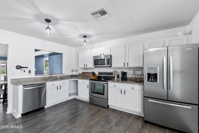 5841 W Kesler St, Chandler, AZ 85226 - kitchen with stainless steel appliances, a sink, white cabinetry, light stone countertops, and dark wood-style floors
