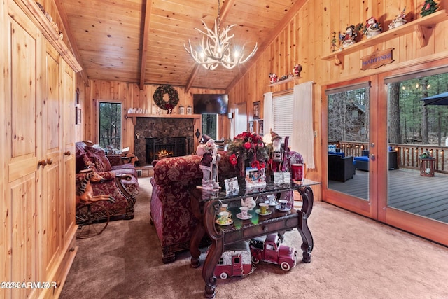 carpeted living room featuring wood ceiling, lofted ceiling, a notable chandelier, and wooden walls