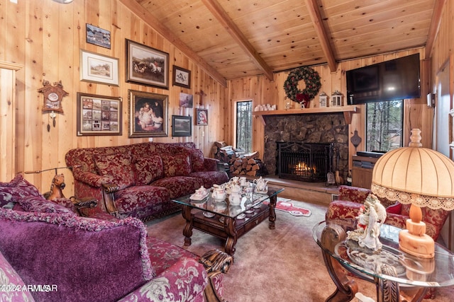 living room with carpet flooring, vaulted ceiling with beams, wooden walls, and a stone fireplace