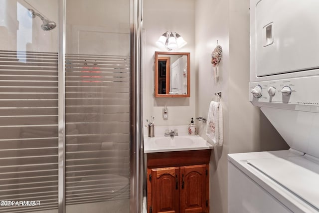 bathroom featuring vanity with extensive cabinet space and stacked washer / drying machine