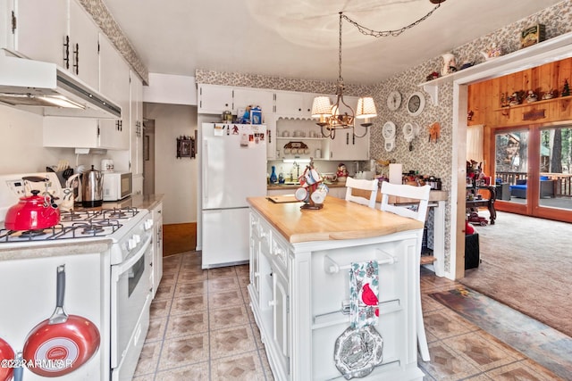 kitchen featuring white cabinets, a notable chandelier, white appliances, and light tile floors