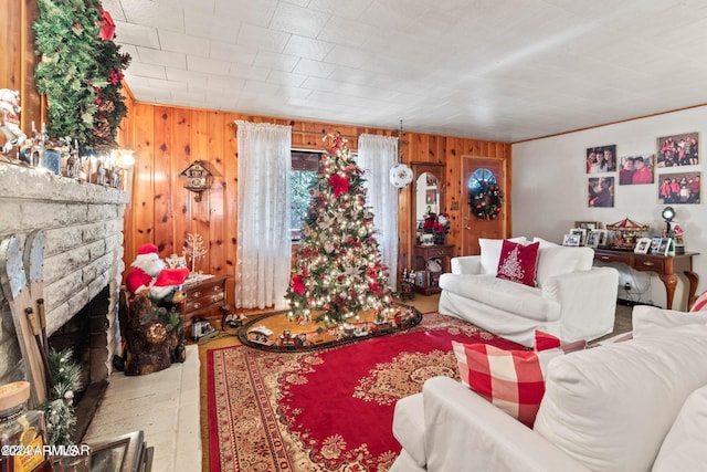 living room with hardwood / wood-style floors, a fireplace, and wood walls