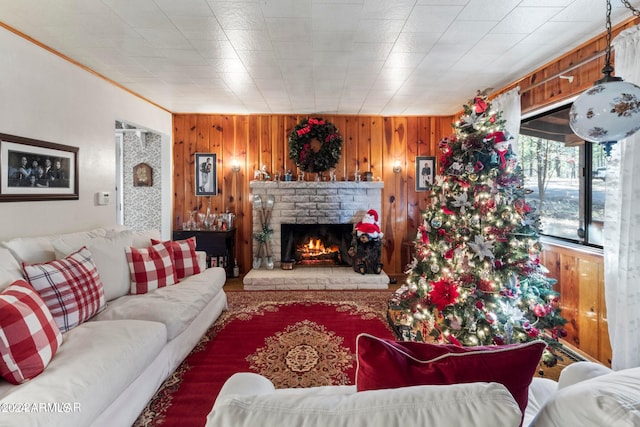 living room with a brick fireplace and wooden walls