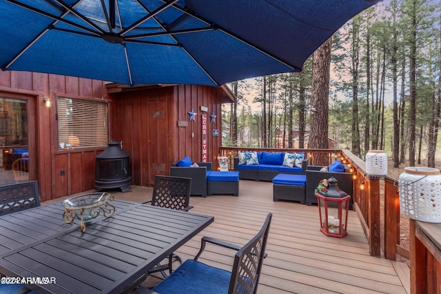 deck at dusk featuring outdoor lounge area