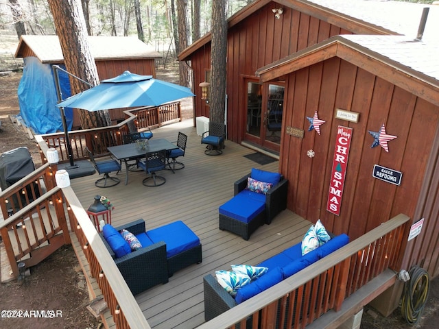 wooden terrace with an outdoor hangout area