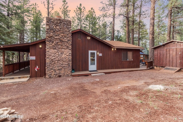 property exterior at dusk with a storage unit