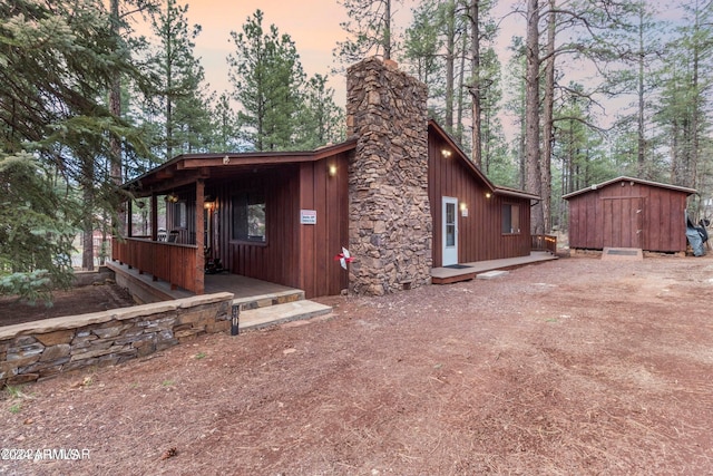 view of front of house with a storage shed