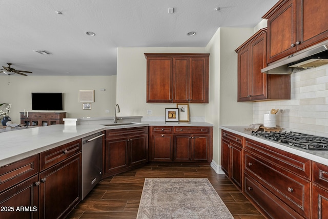 kitchen with open floor plan, light countertops, appliances with stainless steel finishes, and wood tiled floor