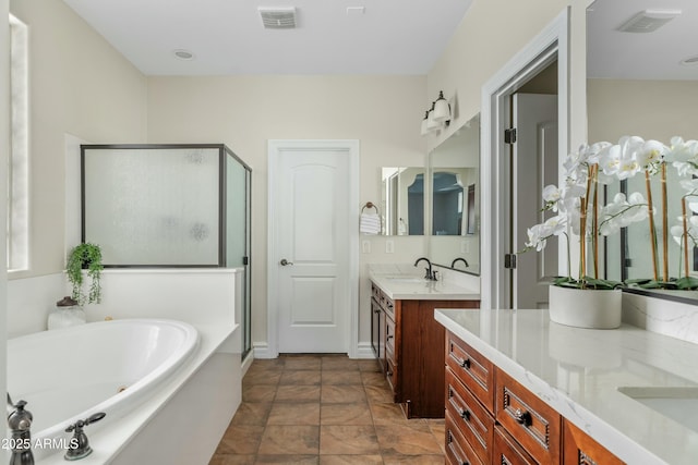 full bathroom with visible vents, a garden tub, a shower stall, and vanity