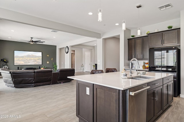 31490 N 126th Ln, Peoria, AZ 85383 - kitchen with dark brown cabinetry, open floor plan, visible vents, stainless steel dishwasher, and a sink