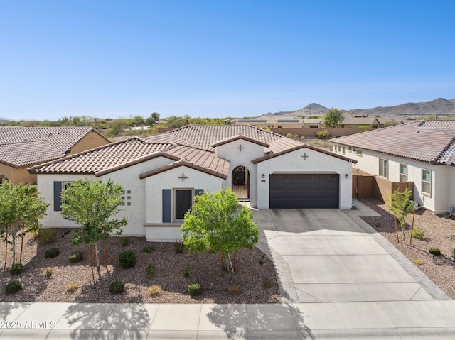 31490 N 126th Ln, Peoria, AZ 85383 - mediterranean / spanish home with concrete driveway, stucco siding, a mountain view, an attached garage, and a tile roof
