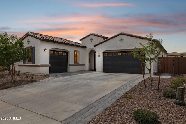 31490 N 126th Ln, Peoria, AZ 85383 - mediterranean / spanish-style house featuring a tiled roof, stucco siding, fence, an attached garage, and driveway