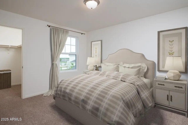 bedroom featuring carpet floors, a closet, a walk in closet, and baseboards