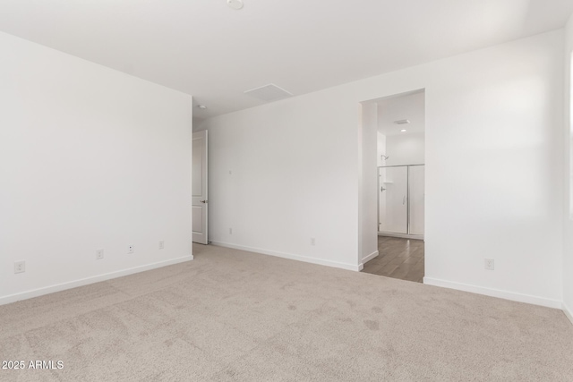 empty room with carpet floors and baseboards