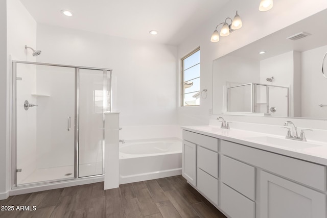 full bath with a sink, visible vents, a bath, and a shower stall